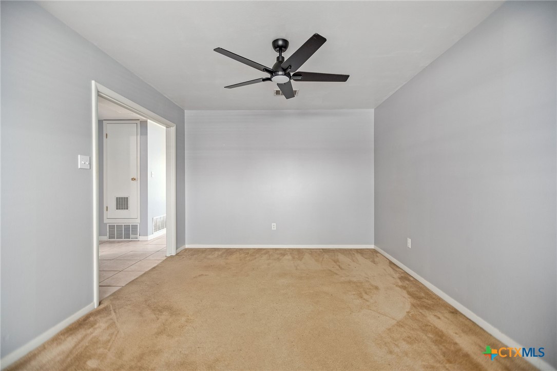 525 Travis Street Port Lavaca, TX 77979 - Photo 5 of 24 a view of a room with a ceiling fan and wooden floor
