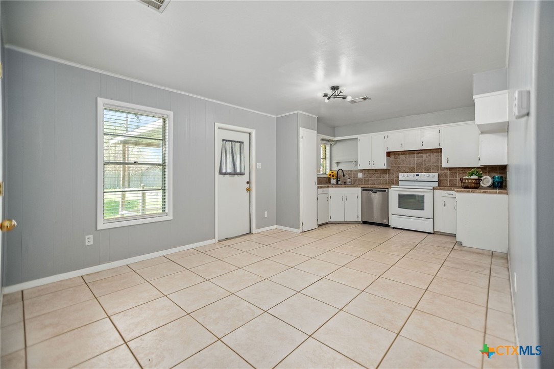 525 Travis Street Port Lavaca, TX 77979 - Photo 6 of 24 a large white kitchen with cabinets