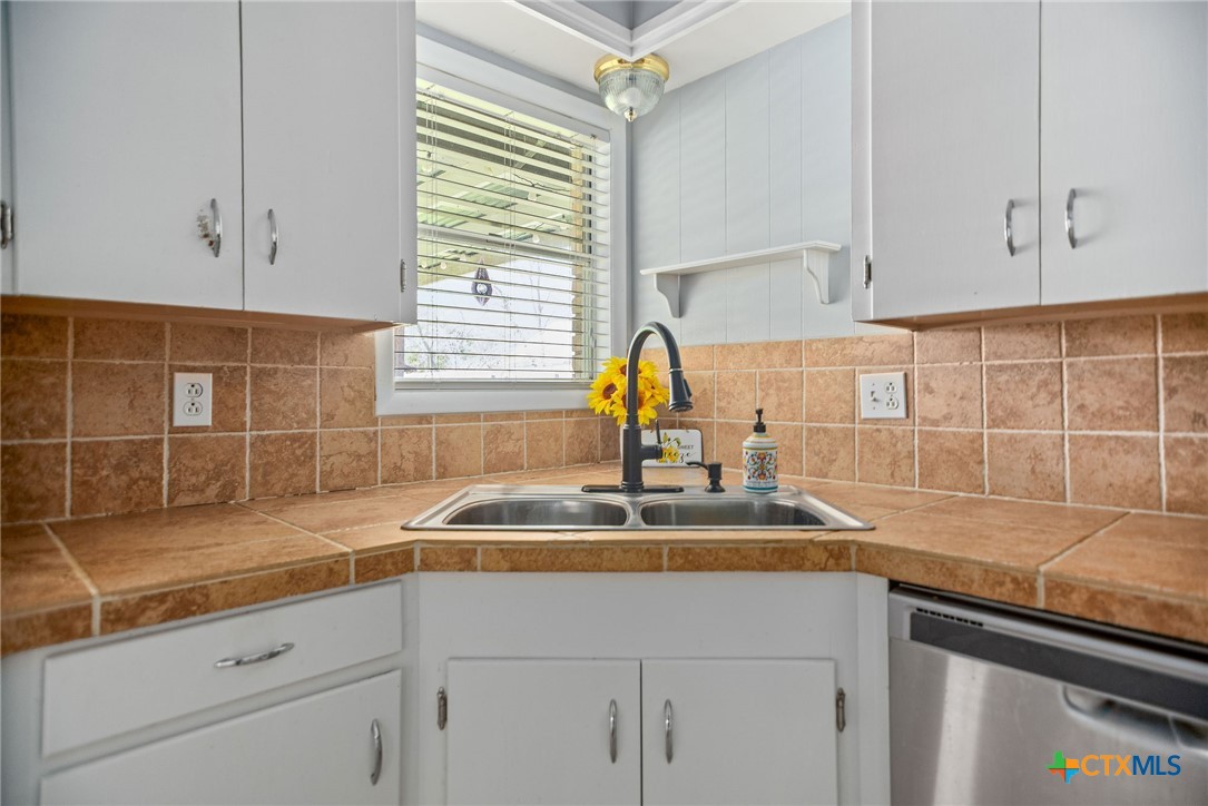 525 Travis Street Port Lavaca, TX 77979 - Photo 8 of 24 a kitchen with a sink cabinets and window