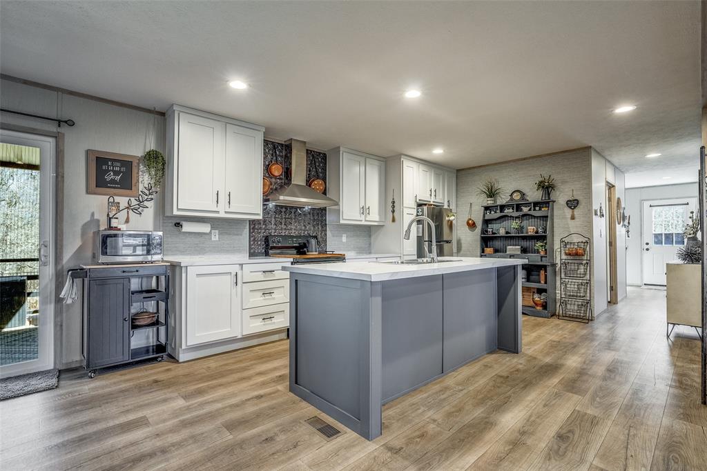 344 Hometown Way Springtown, TX 76082 - Photo 1 of 13 a kitchen with kitchen island granite countertop a sink cabinets and stainless steel appliances