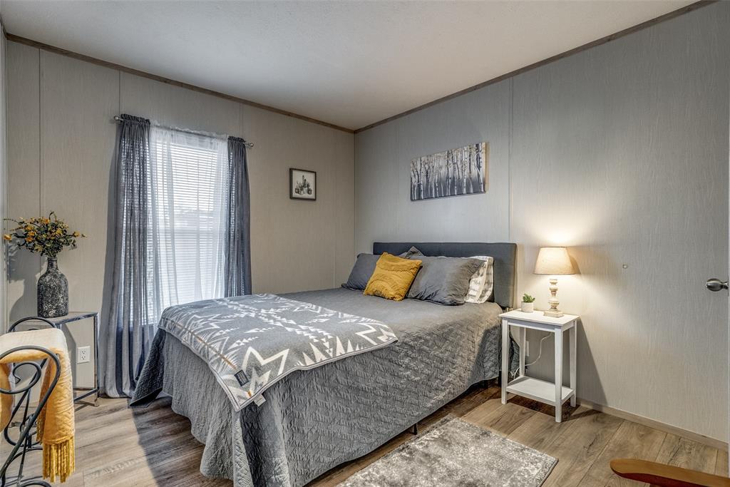344 Hometown Way Springtown, TX 76082 - Photo 7 of 13 a bedroom with a bed and a lamp with window