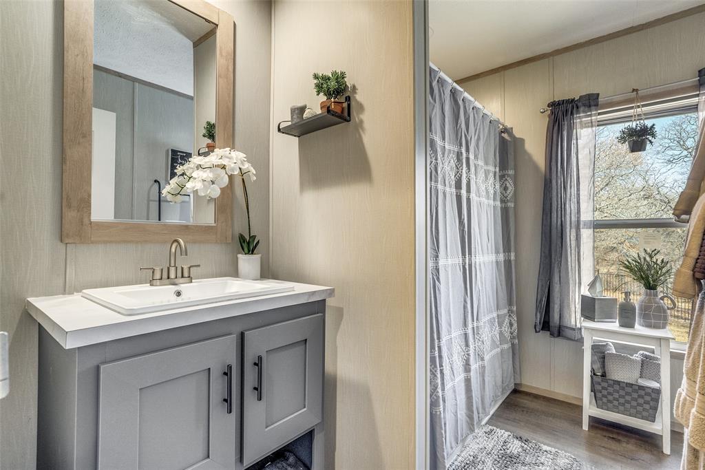 344 Hometown Way Springtown, TX 76082 - Photo 8 of 13 a bathroom with a sink and a mirror