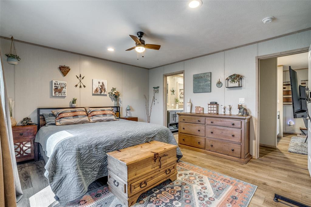 344 Hometown Way Springtown, TX 76082 - Photo 9 of 13 a bedroom with a bed and wooden floor