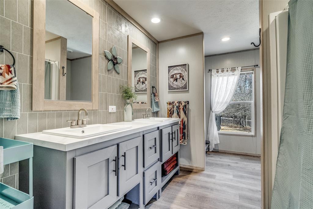 344 Hometown Way Springtown, TX 76082 - Photo 10 of 13 a bathroom with double vanity and a mirror