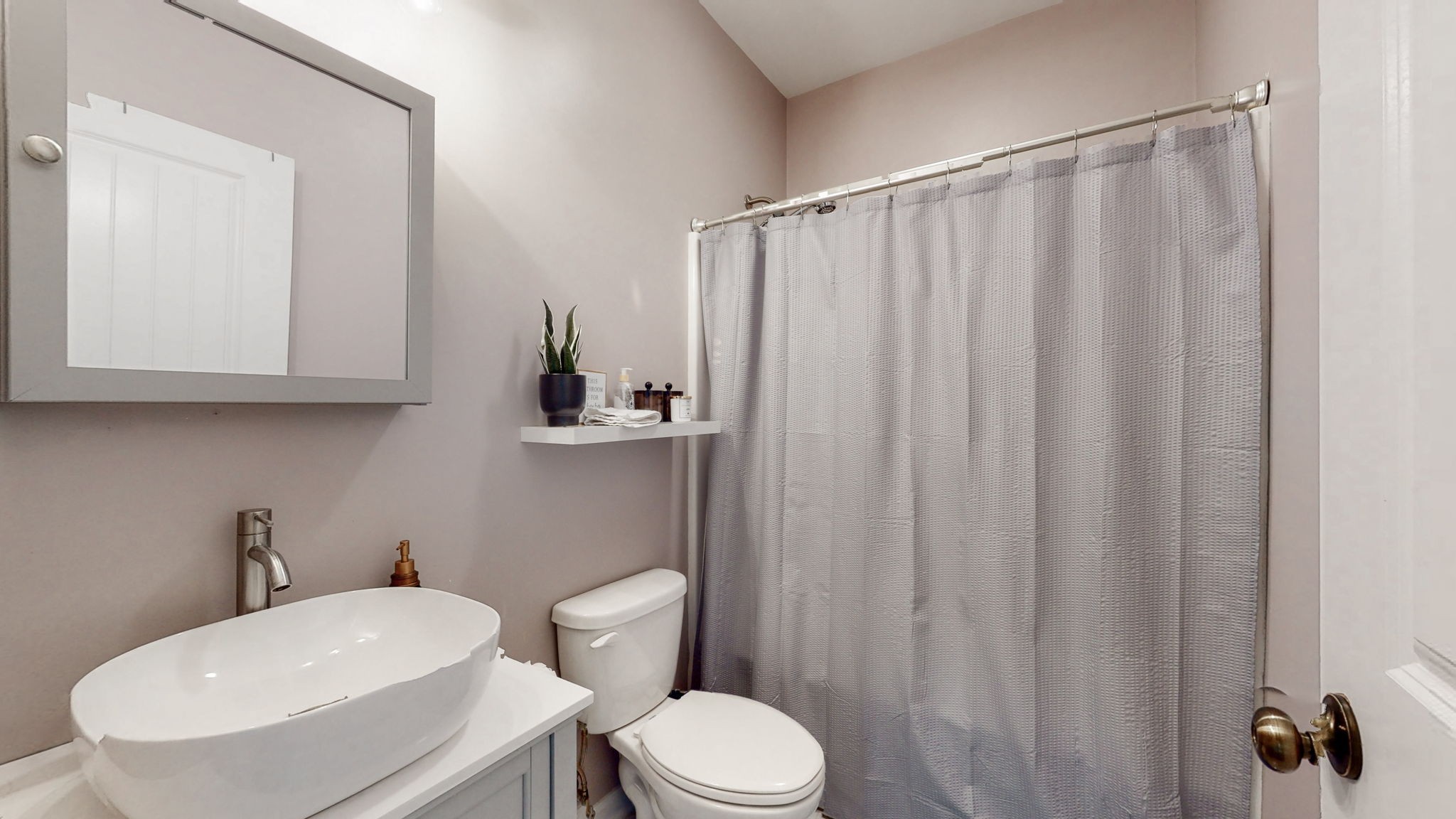 5273 Zander Road Hopkinsville, KY 42240 - Photo 23 of 75 a bathroom with a sink a toilet a mirror and shower curtain