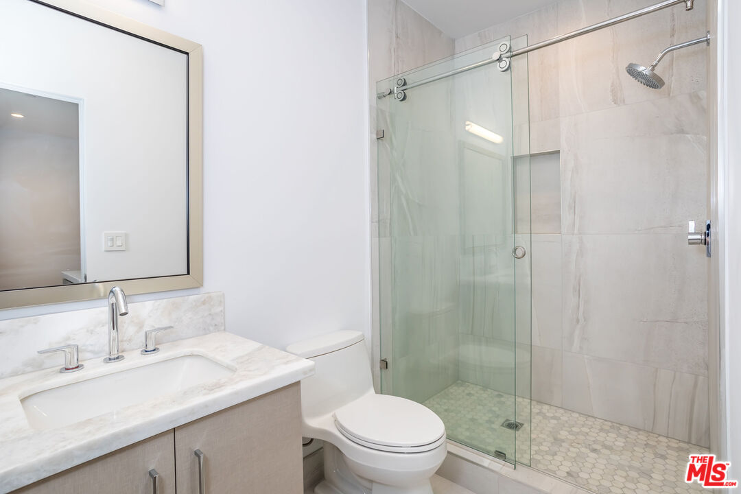 4531 Tujunga Avenue Studio City, CA 91602 - Photo 12 of 49 a bathroom with a sink a toilet and shower