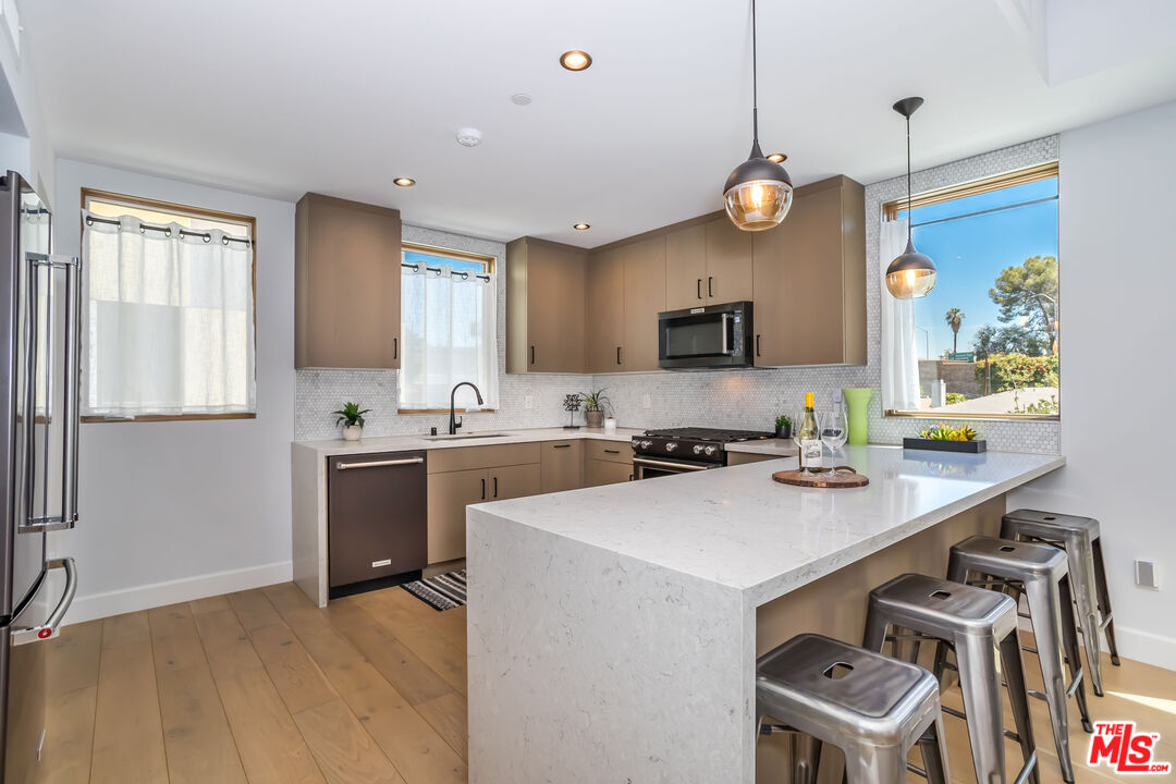 4531 Tujunga Avenue Studio City, CA 91602 - Photo 21 of 49 a kitchen with a sink appliances and cabinets