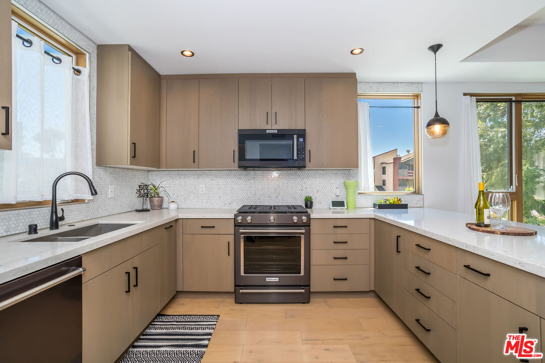 4531 Tujunga Avenue Studio City, CA 91602 - Photo 22 of 49 a kitchen with a sink stove and cabinets