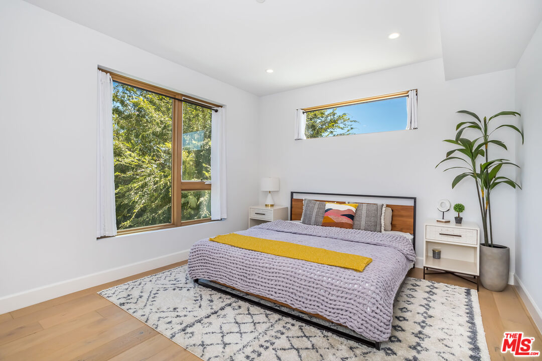 4531 Tujunga Avenue Studio City, CA 91602 - Photo 28 of 49 a bedroom with a bed and a table in it