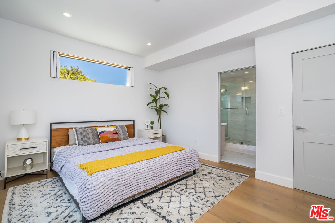 4531 Tujunga Avenue Studio City, CA 91602 - Photo 29 of 49 a bedroom with a bed and glass door