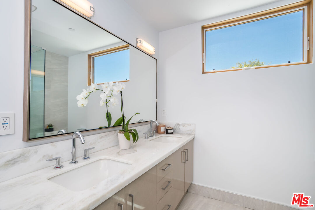 4531 Tujunga Avenue Studio City, CA 91602 - Photo 31 of 49 a bathroom with a double vanity sink and a mirror