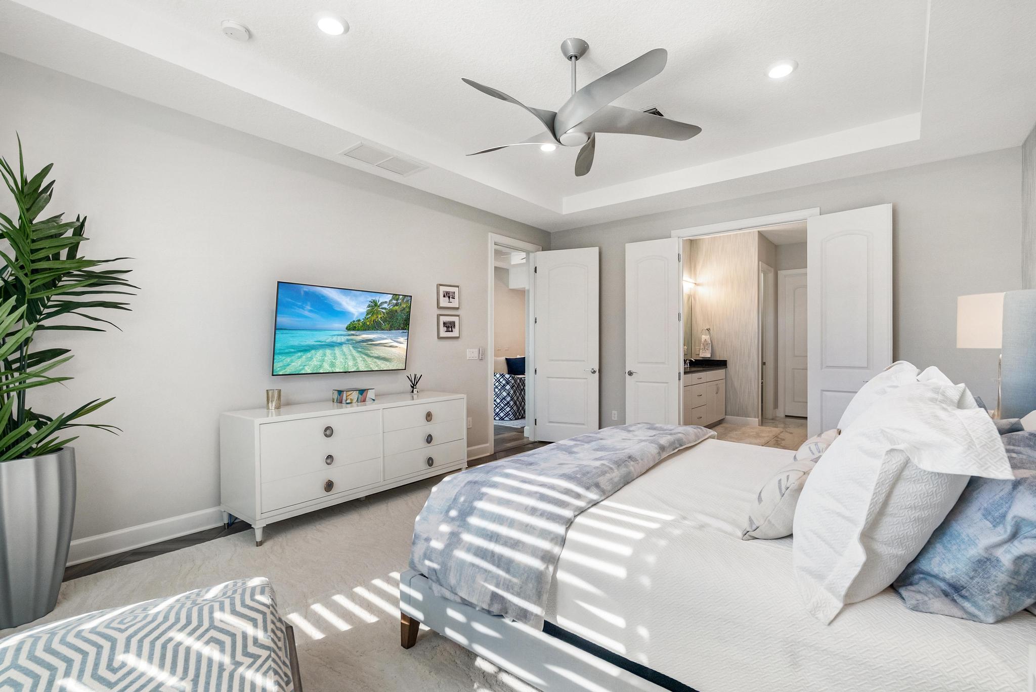 137 Cinder Dunes Point Jupiter, FL 33478 - Photo 11 of 45 a bedroom with a bed and a chandelier