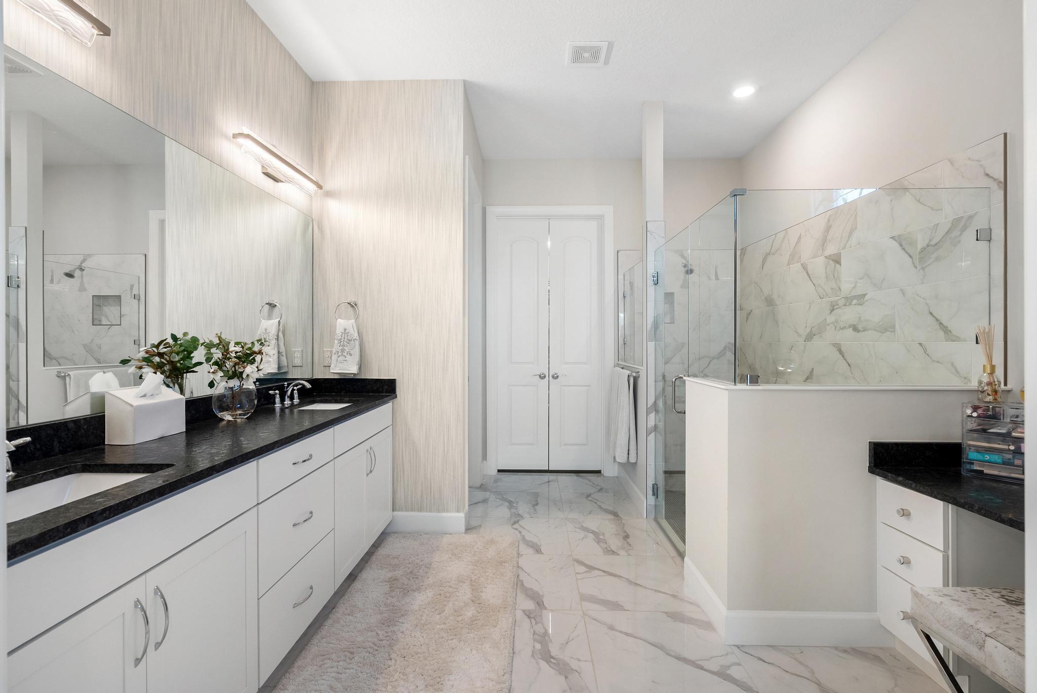 137 Cinder Dunes Point Jupiter, FL 33478 - Photo 12 of 45 a spacious bathroom with a granite countertop sink a mirror and a shower