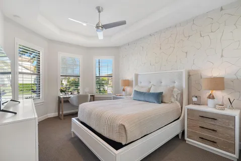 a bedroom with a large bed and a large window