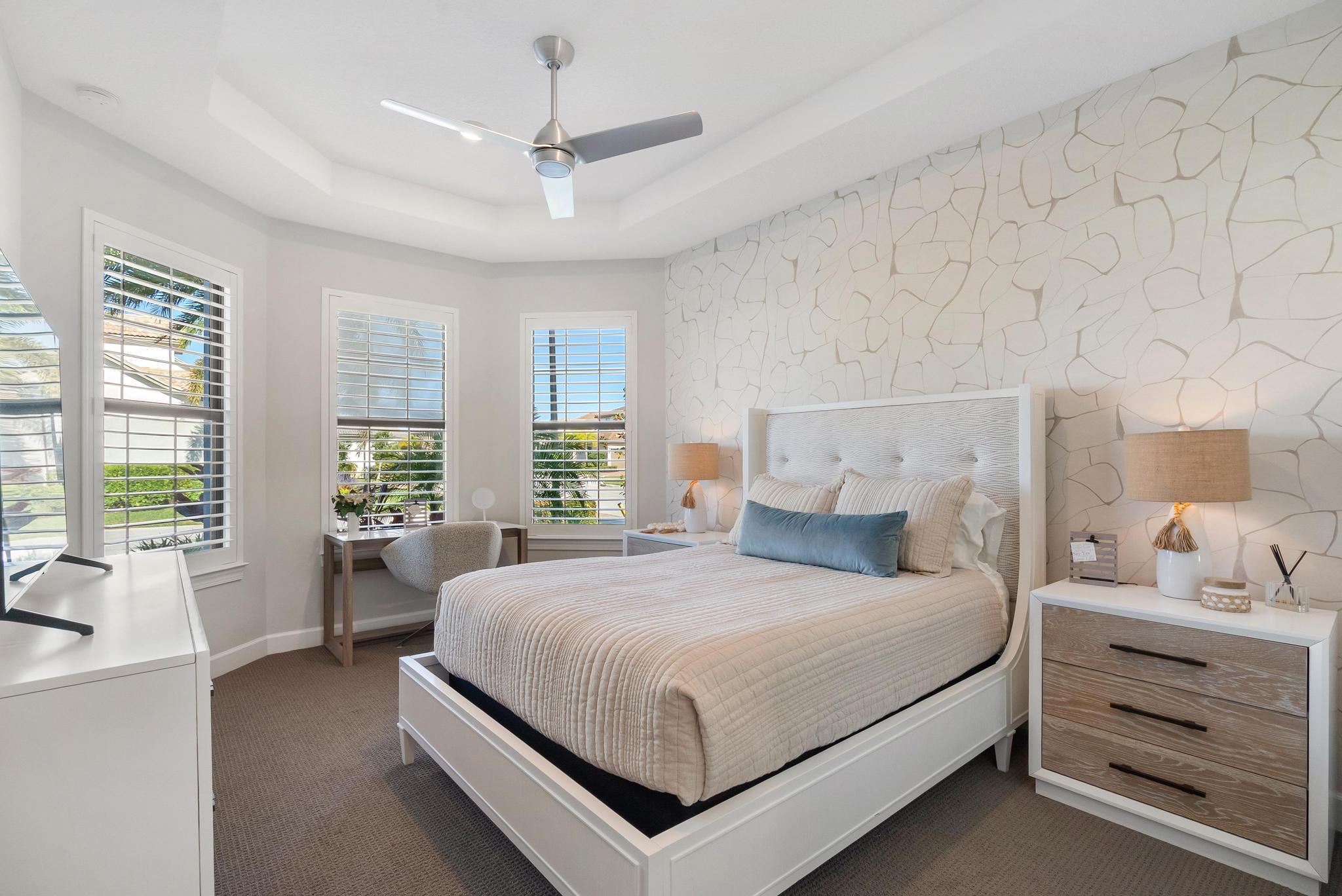 137 Cinder Dunes Point Jupiter, FL 33478 - Photo 14 of 45 a bedroom with a large bed and a large window