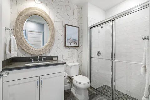 a bathroom with a toilet a sink and a mirror