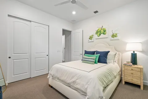 a bedroom with a bed and ceiling fan