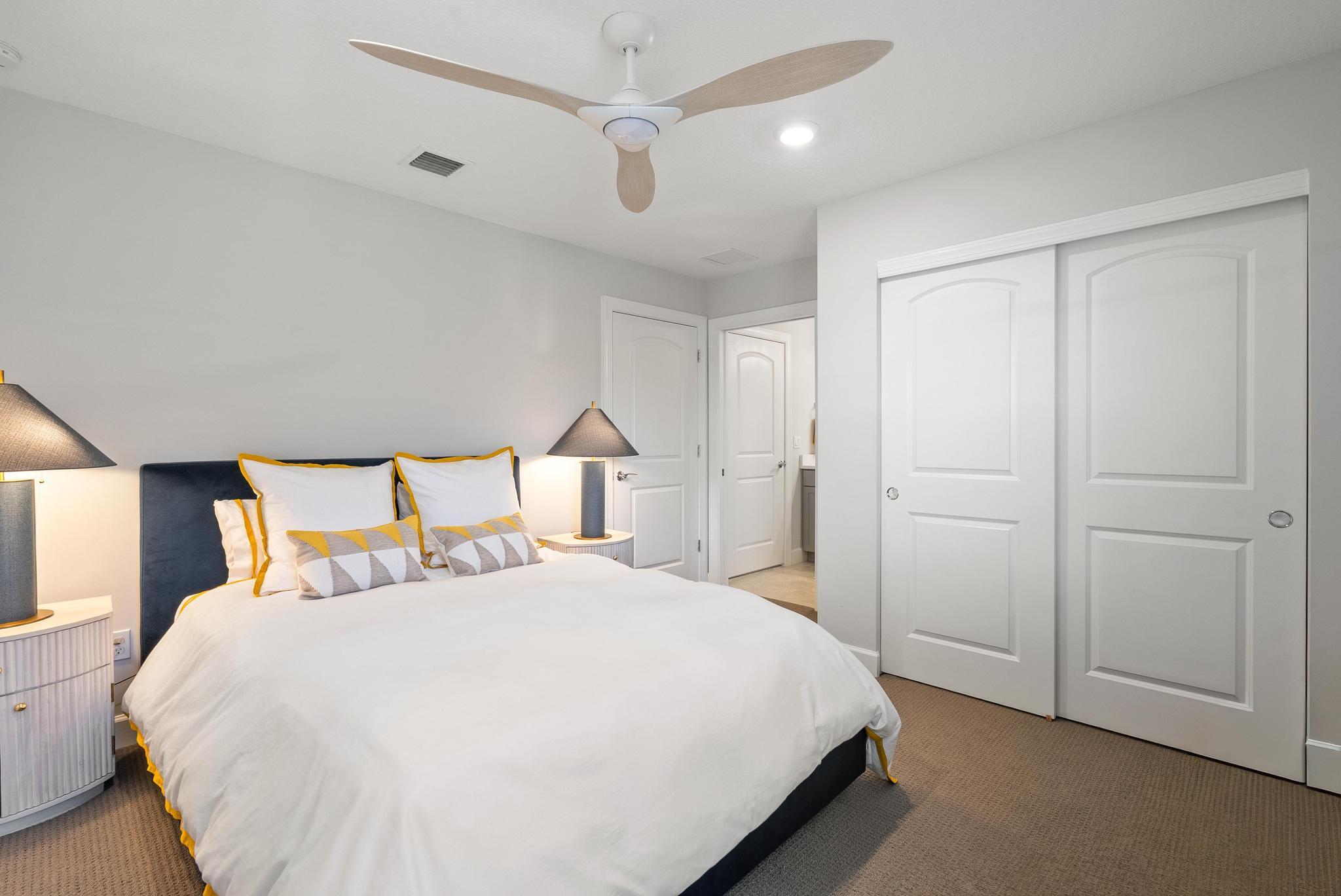 137 Cinder Dunes Point Jupiter, FL 33478 - Photo 19 of 45 a bedroom with a bed and a night stand
