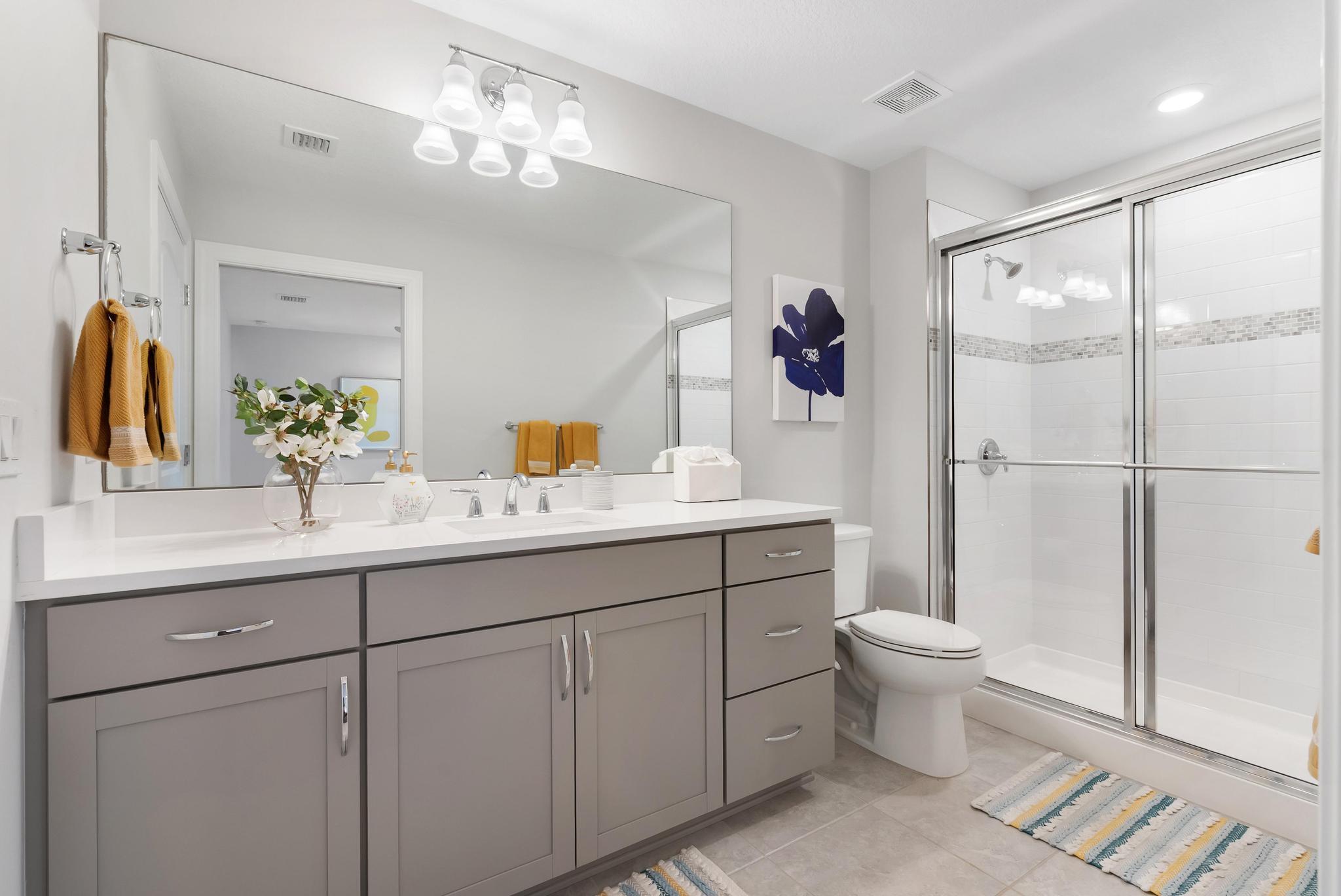 137 Cinder Dunes Point Jupiter, FL 33478 - Photo 20 of 45 a bathroom with a toilet sink double vanity and mirror