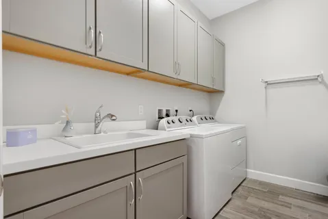 a utility room with sink dryer and washer