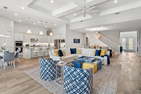 a living room with lots of furniture and kitchen view
