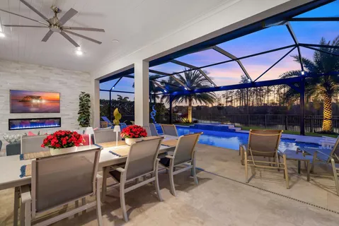 a dining area with a table and chairs