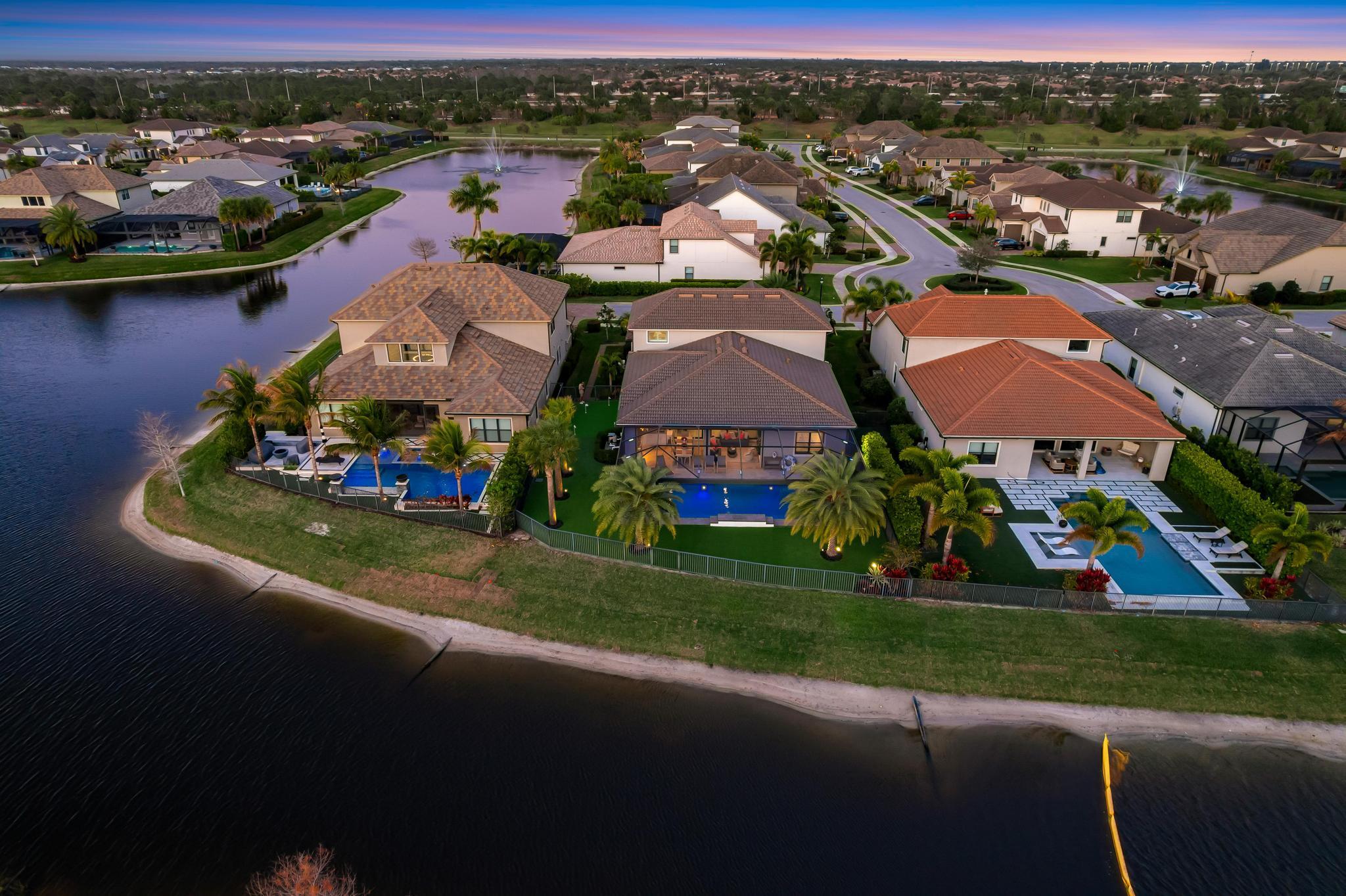 137 Cinder Dunes Point Jupiter, FL 33478 - Photo 38 of 45 an aerial view of residential houses with outdoor space and lake view