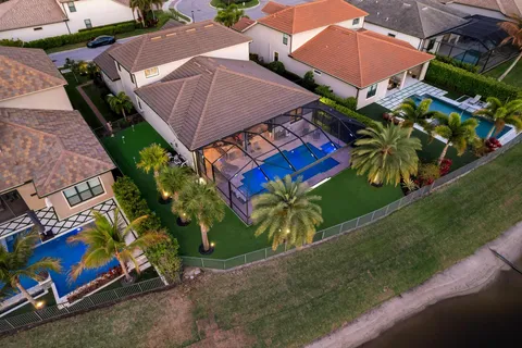 an aerial view of a house with a garden and swimming pool