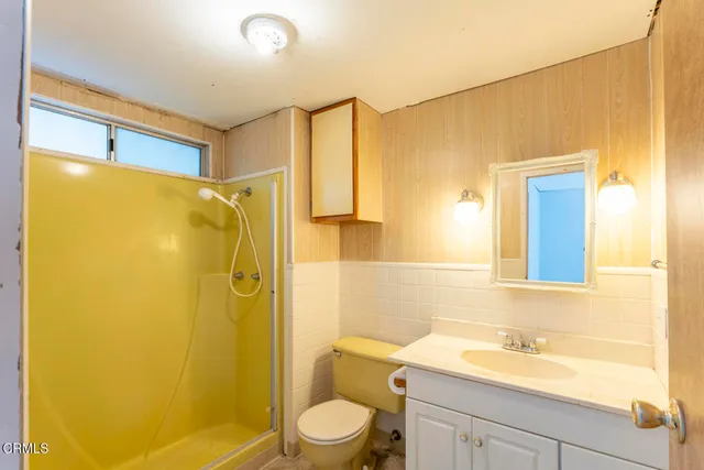 a bathroom with a sink mirror toilet and shower