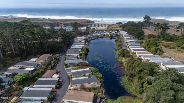 an aerial view of multiple houses with a yard