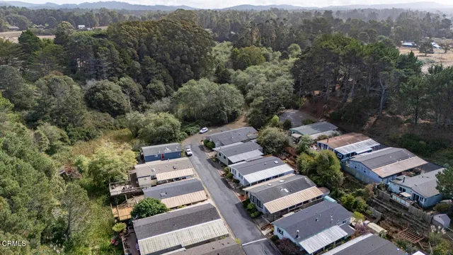 an aerial view of multiple houses with yard