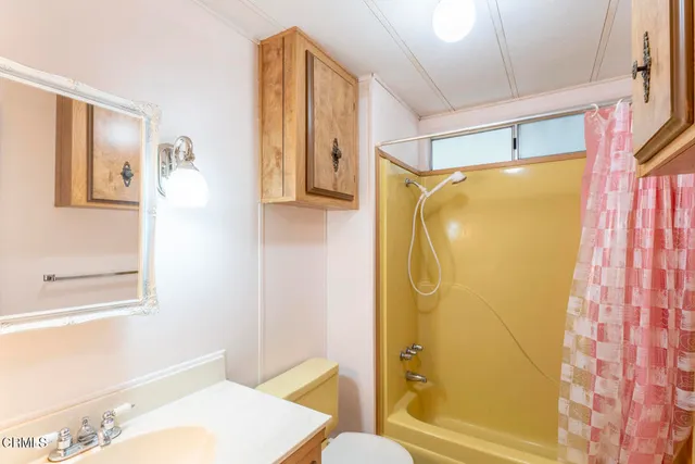 a bathroom with a shower and a toilet