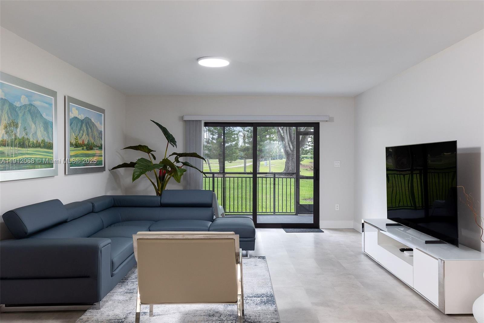 a living room with furniture tv and a flat screen tv