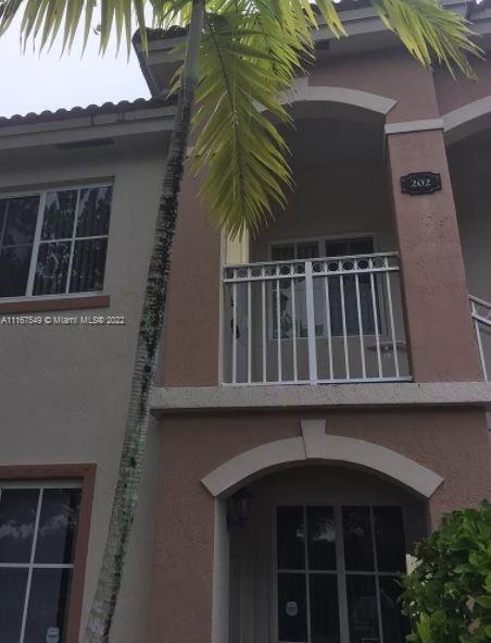 a view of balcony with floor to ceiling window and plants
