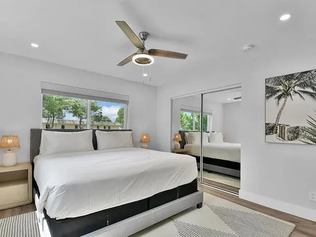 a bedroom with a large bed and a chandelier