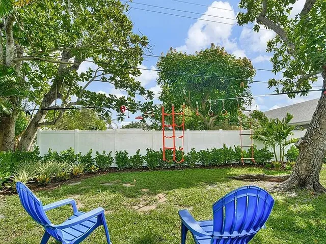a view of a chair and table in the garden