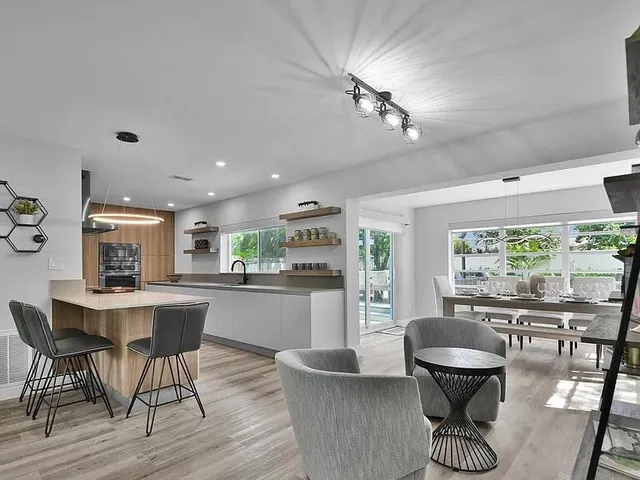 a kitchen with a table chairs and wooden floor
