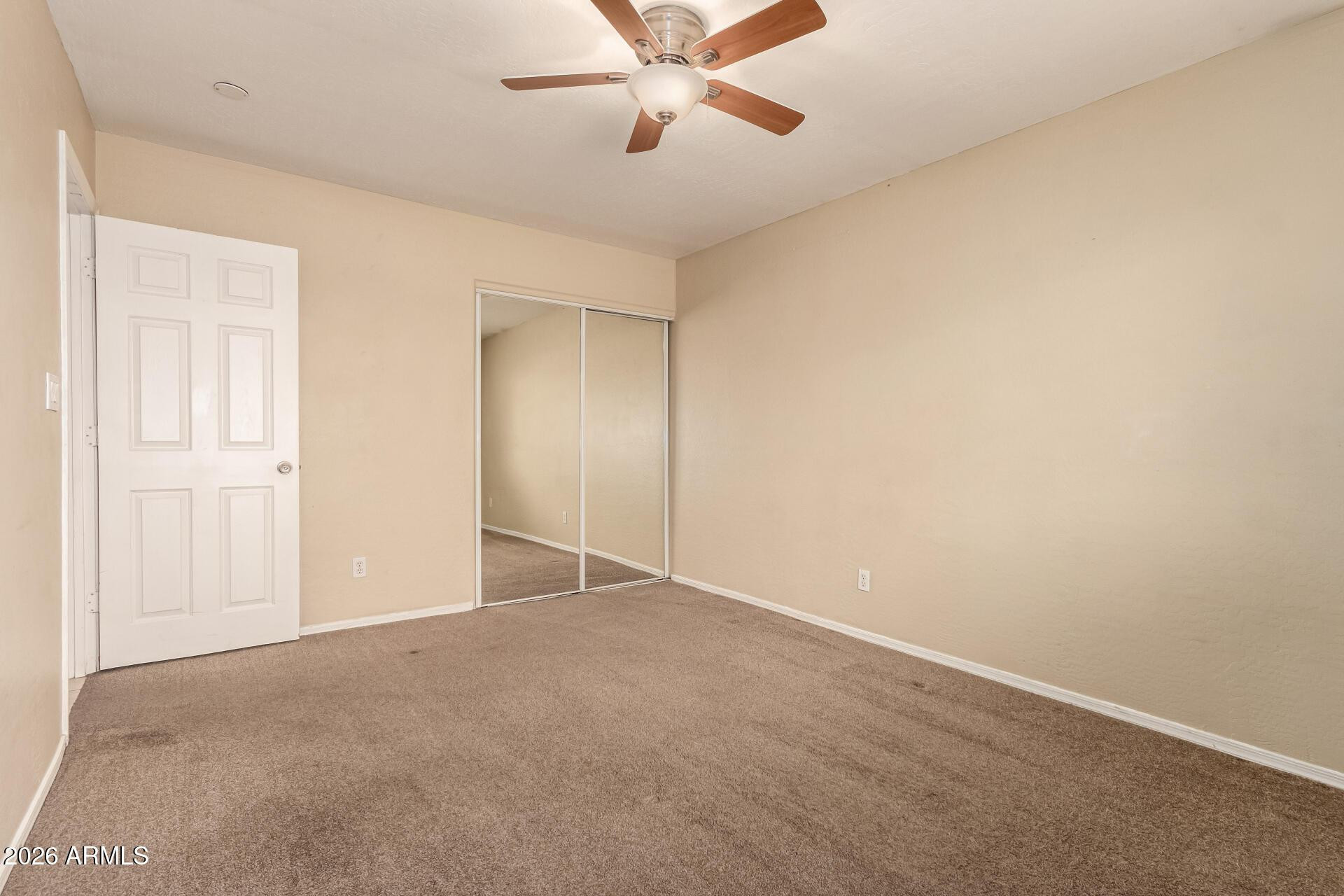 3613 South Kenneth Place Tempe, AZ 85282 - Photo 11 of 17 an empty room with closet and windows