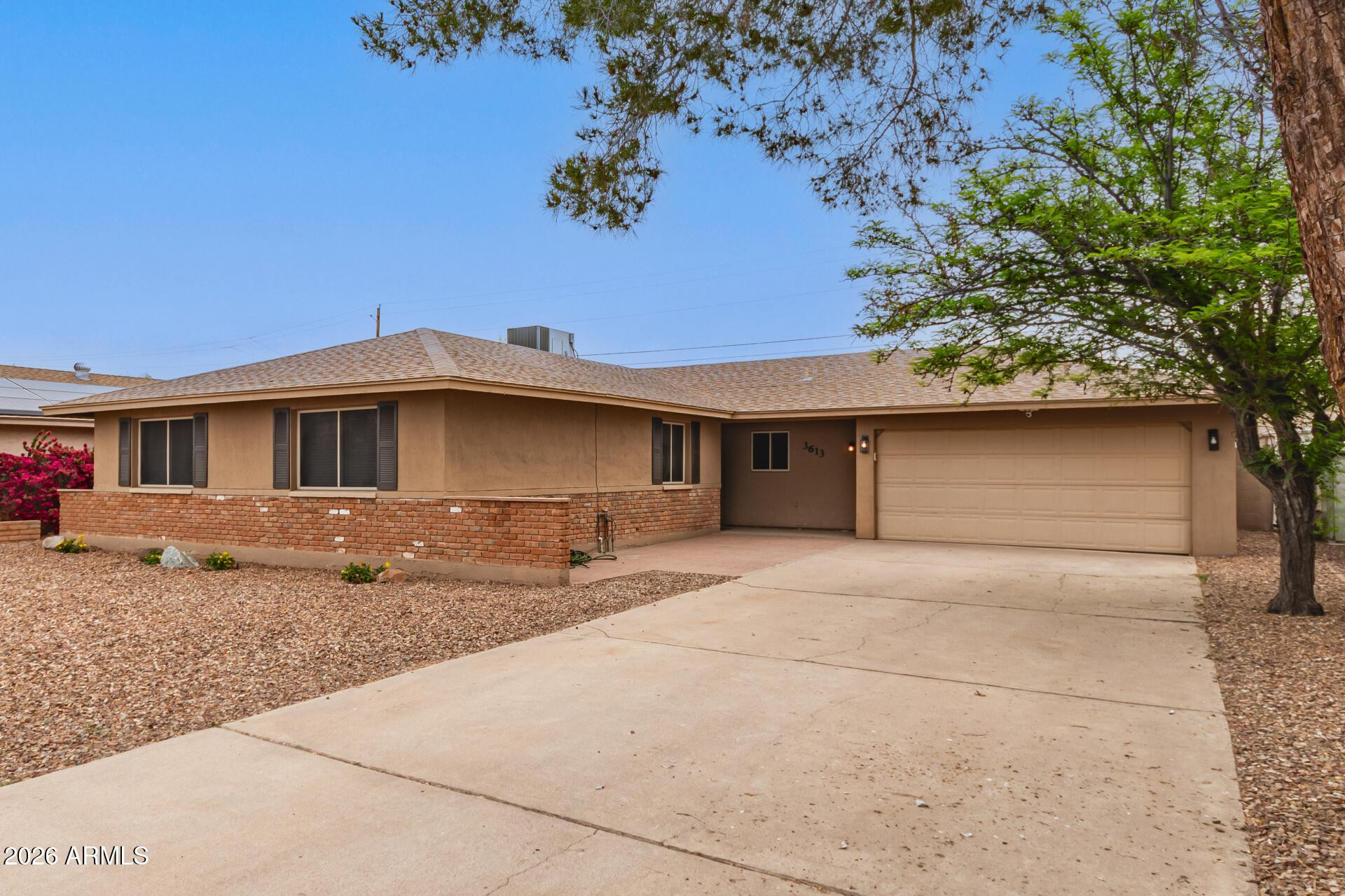 3613 South Kenneth Place Tempe, AZ 85282 - Photo 3 of 17 a front view of a house with a yard and garage
