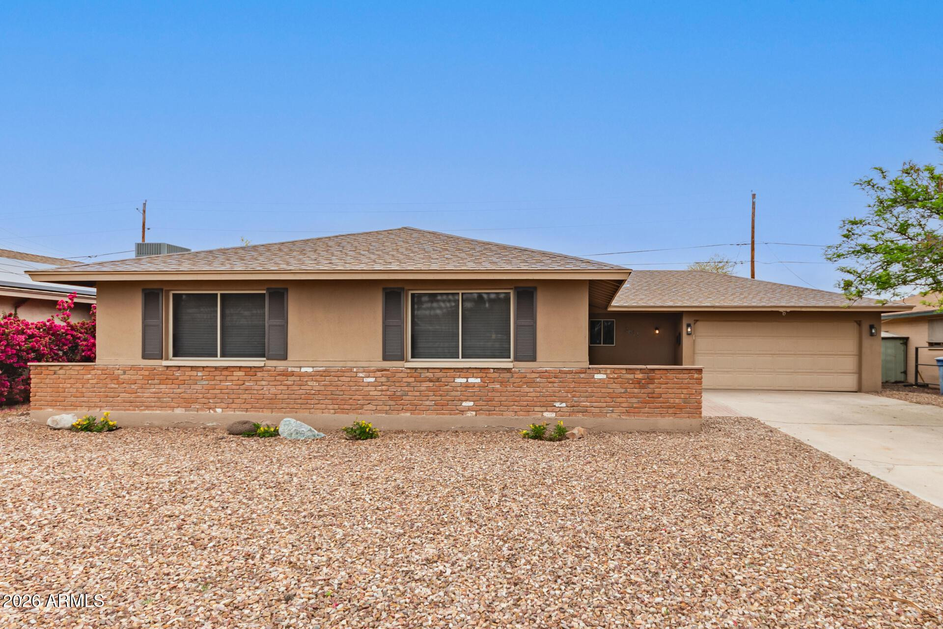 3613 South Kenneth Place Tempe, AZ 85282 - Photo 4 of 17 a front view of a house with a yard and garage