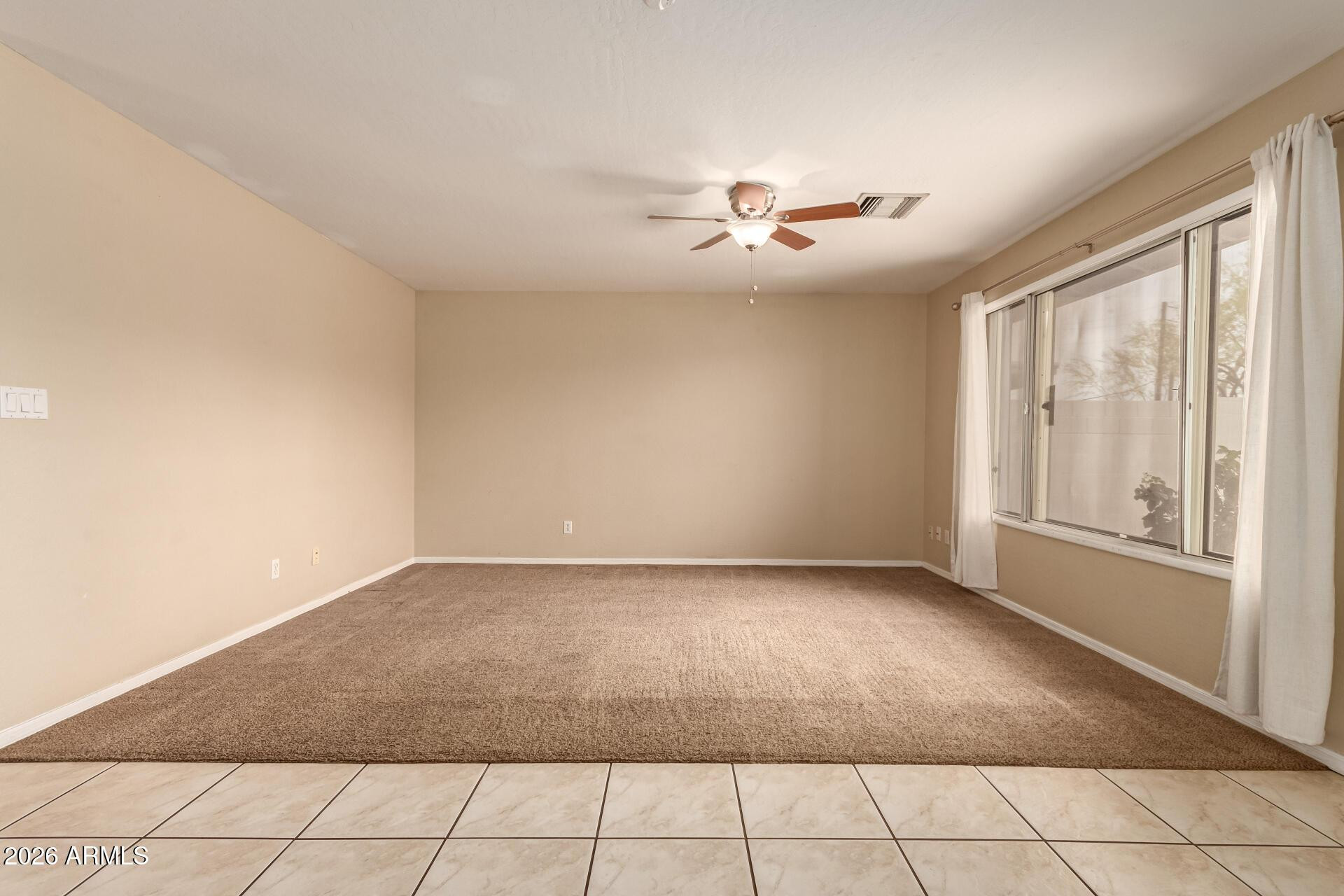 3613 South Kenneth Place Tempe, AZ 85282 - Photo 6 of 17 a view of an empty room with a window