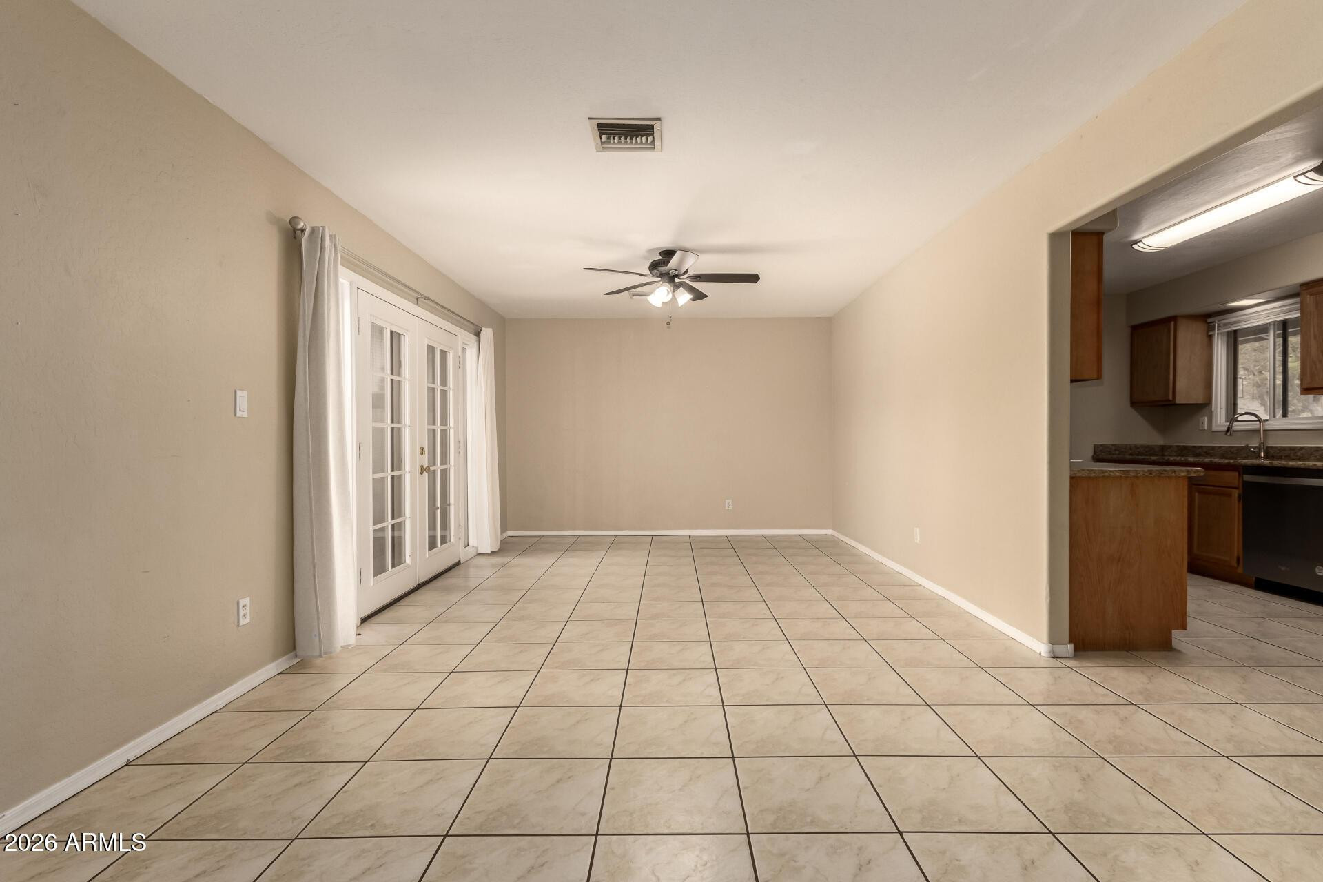 3613 South Kenneth Place Tempe, AZ 85282 - Photo 7 of 17 a view of an empty room with a window
