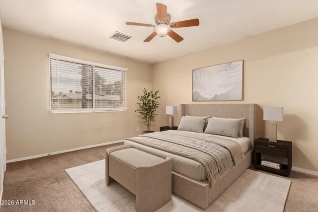 a bedroom with double bed and a window