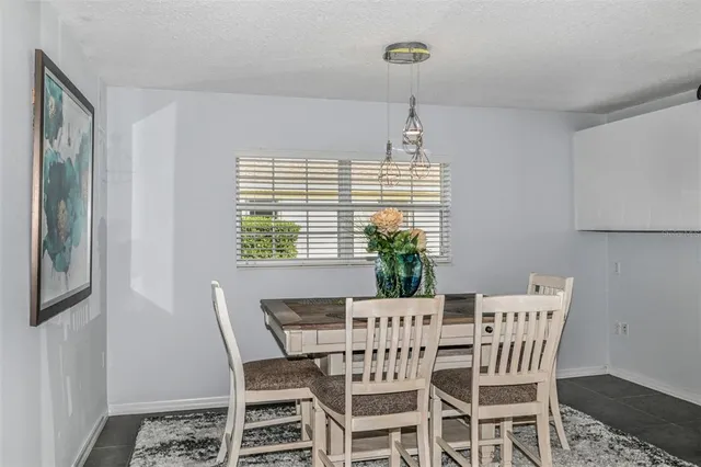 a view of a dining room with furniture and a window