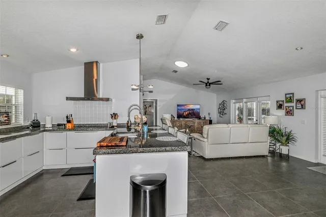 a store room with lots of clutter and stainless steel appliances