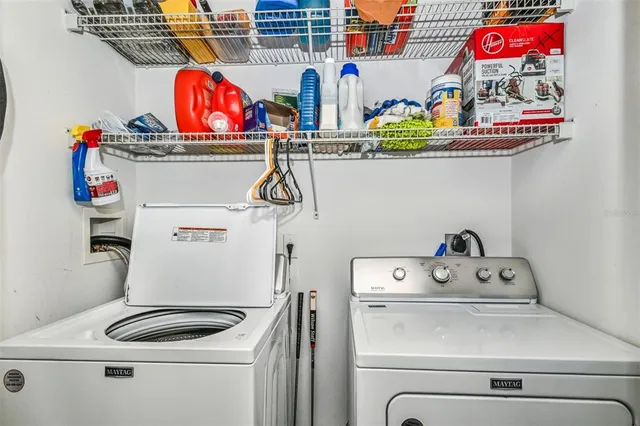 a bedroom with a bed and a dresser with mirror