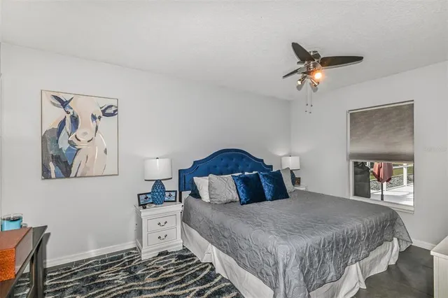 a bedroom with a bed and a lamp on the dresser