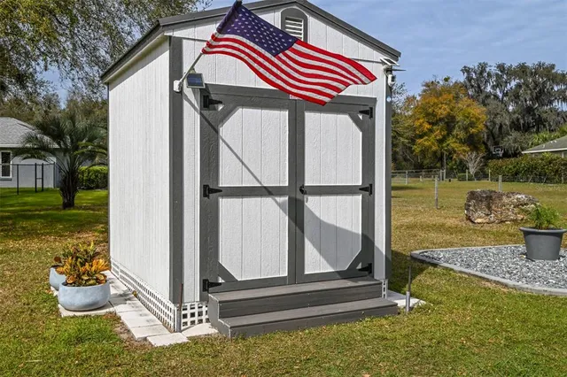 a backyard of a house with lots of green space and wooden fence