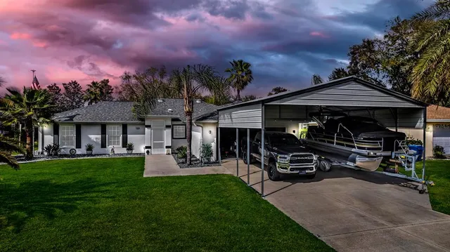 a front view of a house with garden and sitting area