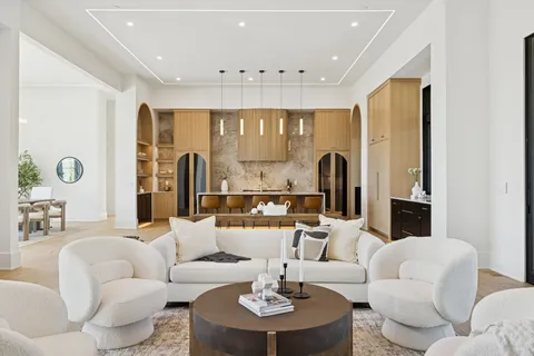 a kitchen with a stove a sink and a refrigerator with wooden floor